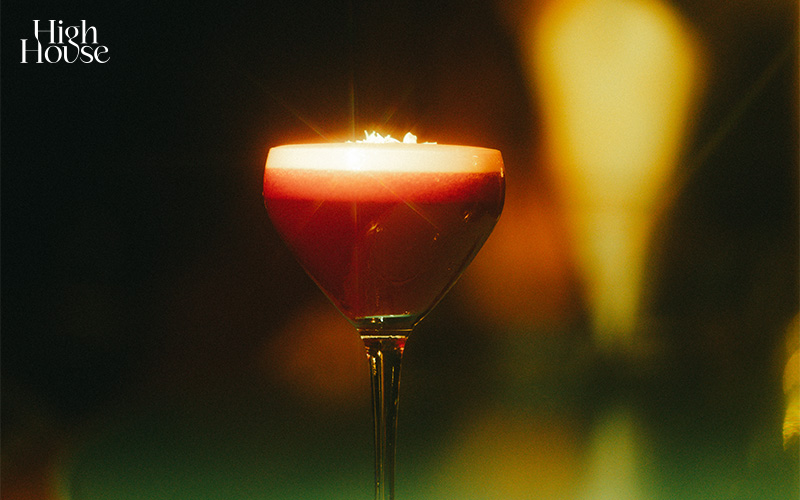 A glass of Old Fashioned at a bar.