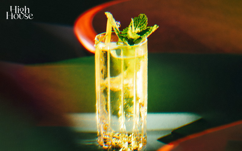 A ruby red cocktail in a coupe glass with a sparkling highlight.