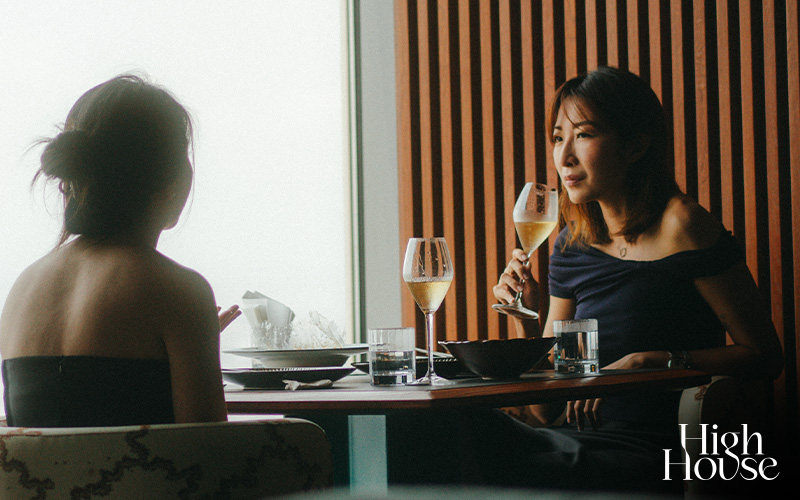 Two women dining at High House with a city view