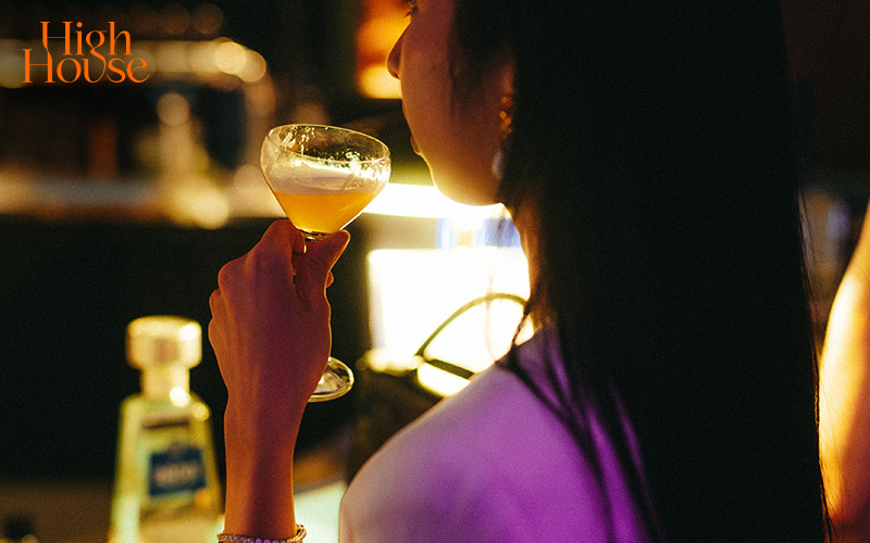 Woman enjoying a cocktail during a solo date.