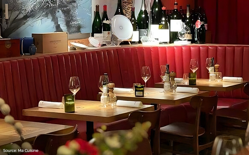 A cozy, private dining area with a red leather booth